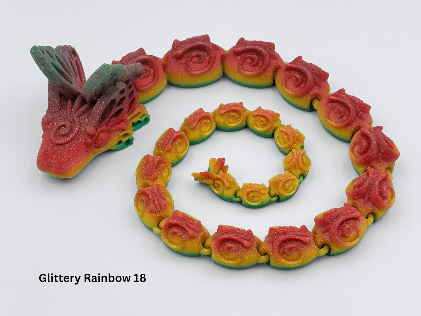 3D-printed Butterfly Snake Dragon with a sleek, elongated body, smooth sinuous curves, sharp ridges along its spine, and a striking blend of sparkling gold and red rainbow scales, showcasing its serpentine elegance and intricate design.